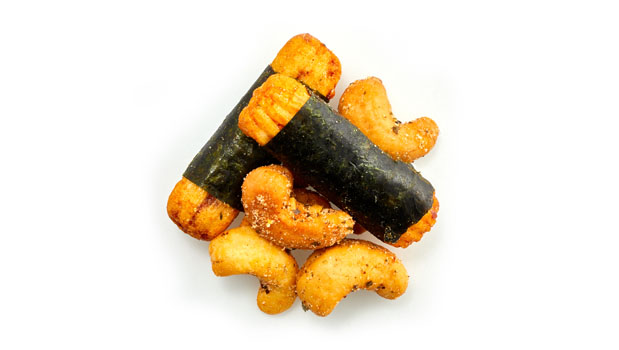 Noix de cajou, Croustilles au sushi [farine de riz, sauce de soja (soja, blé, sel, eau), algue, sucre, fécule de tapioca], Assaisonnement (maltodextrine, sel, epices, ecorce d'orange, extrait de levure, algue, chili gochugaru, extrait de paprika, concentré de jus d'orange, acde citrique, arôme naturel, dioxyde de silicium, huile de tournesol), Huile de canola non-OGM.
Peut contenir: Arachides, Autres noix,  Sésame, Lait, Moutarde, Sulphites, Oeuf, Poisson.