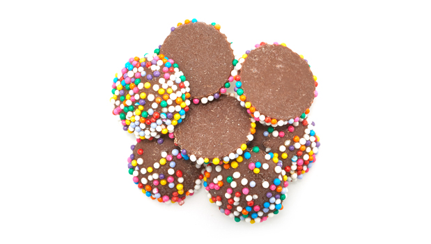 Sugar, Rainbow Nonpareils (Sugar, cornstarch, Contains less than 2% Brilliant Blue FCF (FD&C Blue No. 1), Confectioners glaze, Artificial Colours (Erythrosine (FD&C Red No. 3), Allura Red (FD&C Red No. 40), Tartrazine (FD&C Yellow No. 5), Sunset yellow FCF (FD&C Yellow No. 6), camauba wax), Hydrogenated palm kernel oil, Cocoa powder, Whey powder, Powdered whey protein Concentrate, Chocolate liquor, Cocoa powder (Processed with alkali), Soy lecithin, Natural flavour.
